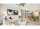 Cozy living room with modern furnishings, ample lighting, and an open layout to the dining and kitchen areas at 819 Steel Dr, Apollo Beach, FL 33572