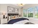 This bedroom features a plush bed with decorative pillows and natural light from the large windows at 819 Steel Dr, Apollo Beach, FL 33572
