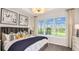 Bright bedroom with a large window, offering a view of the outdoors and an abundance of natural light at 821 Steel Dr, Apollo Beach, FL 33572