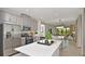 Modern kitchen with stainless steel appliances, quartz countertops, and a central island at 821 Steel Dr, Apollo Beach, FL 33572
