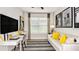 Modern living room with a sleek desk area, sofa, and large windows for ample natural light at 821 Steel Dr, Apollo Beach, FL 33572