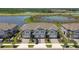Aerial view of townhomes situated on a serene street near a picturesque lake at 8953 Gallantree Pl, Land O Lakes, FL 34637