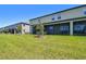 Large, grassy backyard with screened-in patio for outdoor relaxation at 8953 Gallantree Pl, Land O Lakes, FL 34637