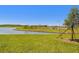 Lush backyard with a view of a serene lake, providing a peaceful and picturesque setting at 8953 Gallantree Pl, Land O Lakes, FL 34637