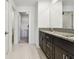 Bathroom features a granite countertop vanity, tile flooring, and a walk-in closet at 8953 Gallantree Pl, Land O Lakes, FL 34637