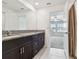 Bright bathroom with granite countertop, modern fixtures, and a view to the bedroom at 8953 Gallantree Pl, Land O Lakes, FL 34637
