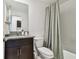 Bathroom featuring granite countertop, toilet and tiled shower at 8953 Gallantree Pl, Land O Lakes, FL 34637