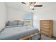 Bedroom featuring a comfortable bed, a ceiling fan, and scenic outdoor views from the window at 8953 Gallantree Pl, Land O Lakes, FL 34637