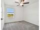 Neutral bedroom featuring a ceiling fan and a serene lake view at 8953 Gallantree Pl, Land O Lakes, FL 34637