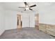 Spacious bedroom with a ceiling fan and connecting doors to a walk-in closet and another room at 8953 Gallantree Pl, Land O Lakes, FL 34637