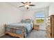Bedroom with comfortable bed and natural light from a window with scenic outdoor views at 8953 Gallantree Pl, Land O Lakes, FL 34637