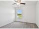 Carpeted bedroom featuring a serene lake view and ceiling fan at 8953 Gallantree Pl, Land O Lakes, FL 34637