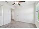 Bright bedroom with neutral carpet, ceiling fan, and a window for natural light at 8953 Gallantree Pl, Land O Lakes, FL 34637