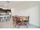 Open dining area features a wood table and is adjacent to a modern kitchen with stainless steel appliances at 8953 Gallantree Pl, Land O Lakes, FL 34637