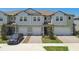 Beautiful townhome with a two-car garage, and a professionally landscaped front yard at 8953 Gallantree Pl, Land O Lakes, FL 34637