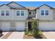 Charming townhome with a well-manicured front yard and a two-car garage, offering curb appeal at 8953 Gallantree Pl, Land O Lakes, FL 34637
