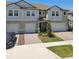 Charming townhome with two-car garage, landscaped front yard and welcoming front door at 8953 Gallantree Pl, Land O Lakes, FL 34637