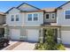 Charming townhome with a two-car garage and a landscaped front yard at 8953 Gallantree Pl, Land O Lakes, FL 34637