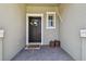Charming entrance featuring a wreath, a 'welcome' mat, and two wicker baskets at 8953 Gallantree Pl, Land O Lakes, FL 34637