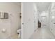 Hallway with a half bath on the left and the entry door at the end at 8953 Gallantree Pl, Land O Lakes, FL 34637