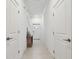 Bright hallway with neutral tile flooring, white walls, and a small console table at 8953 Gallantree Pl, Land O Lakes, FL 34637