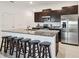 Stylish kitchen island with seating and stainless steel appliances at 8953 Gallantree Pl, Land O Lakes, FL 34637