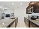 Eat-in kitchen with granite countertops and stainless appliances adjacent to the living room at 8953 Gallantree Pl, Land O Lakes, FL 34637