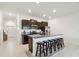 Modern kitchen with dark cabinetry, stainless steel appliances, and granite countertops at 8953 Gallantree Pl, Land O Lakes, FL 34637