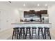 Bright kitchen featuring a spacious island with barstool seating and stainless steel appliances at 8953 Gallantree Pl, Land O Lakes, FL 34637