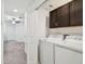 Laundry room featuring a modern washer and dryer, with upper cabinets for storage at 8953 Gallantree Pl, Land O Lakes, FL 34637