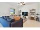 Comfortable living room with bright window views and modern shelving at 8953 Gallantree Pl, Land O Lakes, FL 34637