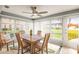 Bright dining area with multiple windows, a ceiling fan, and comfortable seating at 101 Dogwood Cir, Seminole, FL 33777