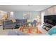 Comfortable living room featuring a large sofa, area rug, and stylish decor at 101 Dogwood Cir, Seminole, FL 33777