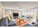 Bright living room with plush seating, colorful rug, and open dining area offers a cozy and inviting atmosphere at 101 Dogwood Cir, Seminole, FL 33777