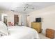 Cozy main bedroom with ceiling fan, dresser, and access to closet and en-suite bathroom at 101 Dogwood Cir, Seminole, FL 33777