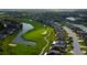Aerial view of a community with a golf course, ponds and manicured landscaping at 10103 Old Tampa Bay Dr, San Antonio, FL 33576