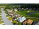 Scenic aerial view of a residential neighborhood featuring lush landscaping, a golf course, and a pond at 10103 Old Tampa Bay Dr, San Antonio, FL 33576