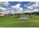 Scenic backyard view overlooking a pond and the manicured lawn at 10103 Old Tampa Bay Dr, San Antonio, FL 33576