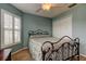 Bedroom with light blue walls, carpet, ceiling fan, and windows with white shutters at 10103 Old Tampa Bay Dr, San Antonio, FL 33576