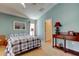 Bedroom with blue walls, a patterned bedspread, and an antique table at 10103 Old Tampa Bay Dr, San Antonio, FL 33576