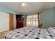 Bedroom with blue walls, a patterned bedspread, and a window at 10103 Old Tampa Bay Dr, San Antonio, FL 33576