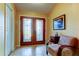 Bright entryway with double doors, neutral walls, ceramic tile flooring, and traditional furnishings at 10103 Old Tampa Bay Dr, San Antonio, FL 33576