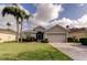Beautiful single-story home with a two-car garage, paver driveway, and lush landscaping at 10103 Old Tampa Bay Dr, San Antonio, FL 33576