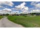 Picturesque golf course and walking path surrounded by lush greenery and trees at 10103 Old Tampa Bay Dr, San Antonio, FL 33576