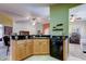 Kitchen featuring wooden cabinets, black countertops, a sink, and a dishwasher at 10103 Old Tampa Bay Dr, San Antonio, FL 33576