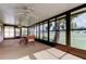 Enclosed lanai featuring dining furniture with views of the outdoor landscape and ceiling fans at 10103 Old Tampa Bay Dr, San Antonio, FL 33576