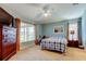 Spacious main bedroom with neutral carpeting, ceiling fan, and large windows providing ample natural light at 10103 Old Tampa Bay Dr, San Antonio, FL 33576