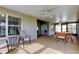 View of covered patio with ceiling fans, table and chairs, and sliding glass doors leading to additional patio space at 10103 Old Tampa Bay Dr, San Antonio, FL 33576