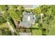 An aerial view shows the roof, backyard, pool, hot tub, and landscaping of this home at 1058 Roundstone Pl, Palm Harbor, FL 34683