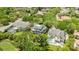 Aerial view of a home featuring well-manicured landscaping, a pool, and a golf course nearby at 1058 Roundstone Pl, Palm Harbor, FL 34683